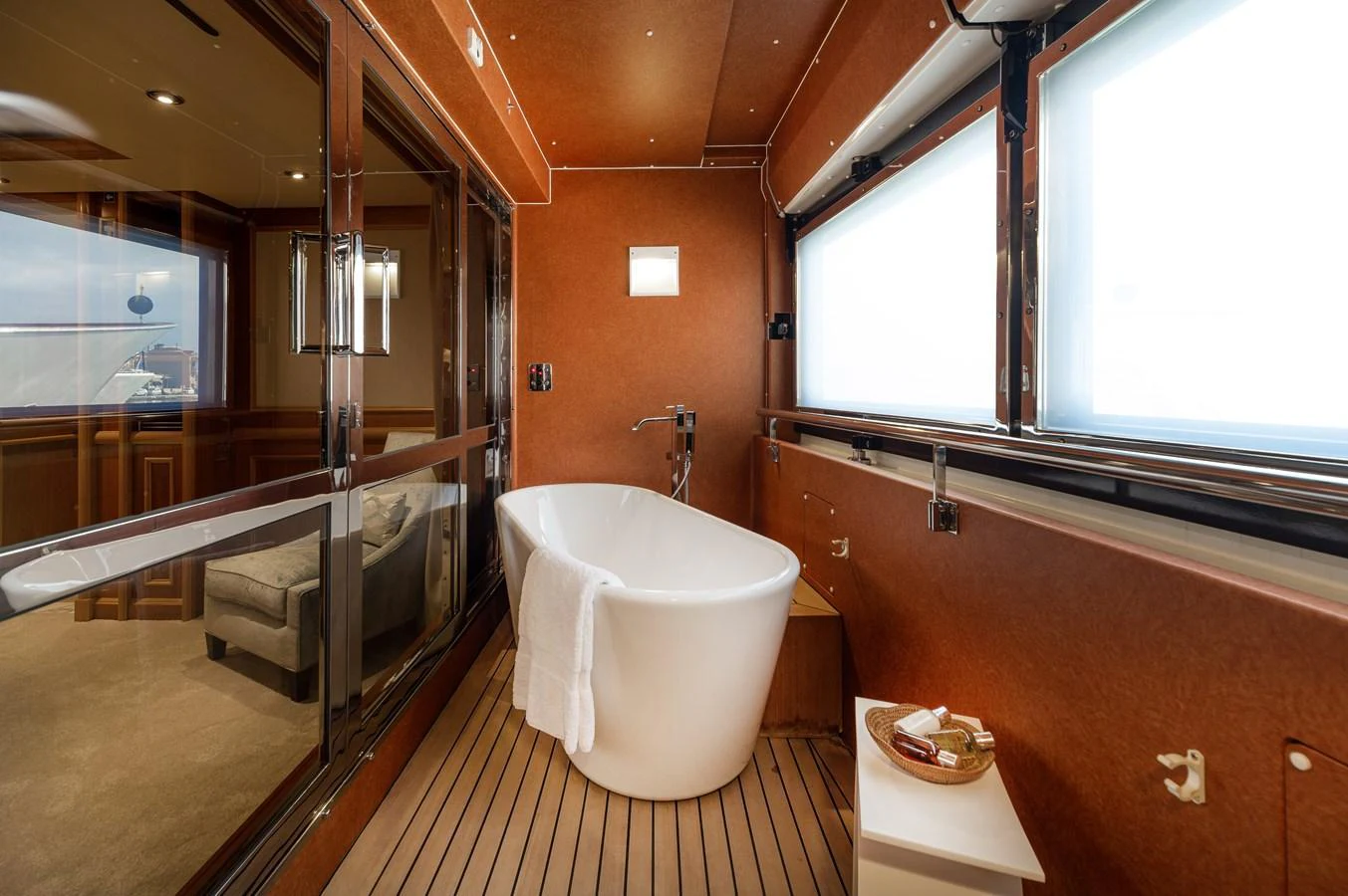 A luxurious bathroom with a freestanding bathtub and large windows offering ample natural light. aboard EMOTION 2 Yacht for Sale