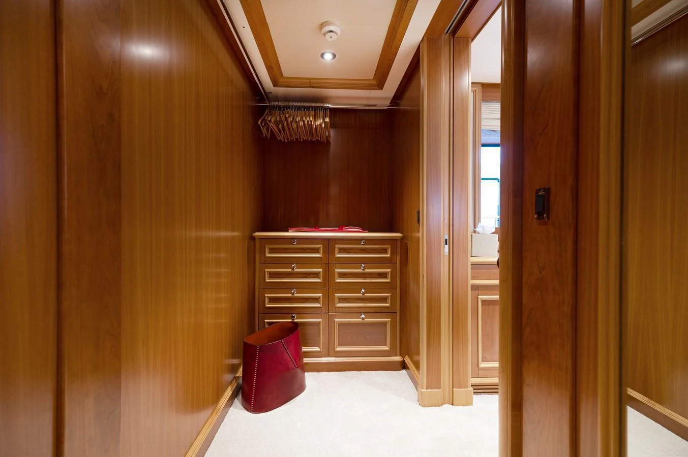 This image showcases a well-appointed wooden closet area with ample storage space. aboard EMOTION 2 Yacht for Sale