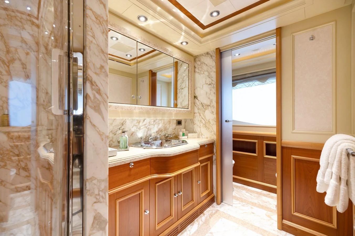The bathroom features luxurious marble surfaces and elegant wooden cabinetry. aboard EMOTION 2 Yacht for Sale