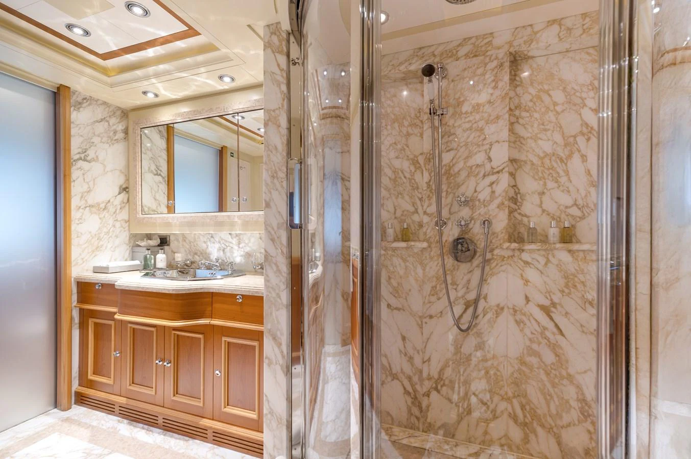 The luxurious bathroom features elegant marble walls and a spacious shower area. aboard EMOTION 2 Yacht for Sale