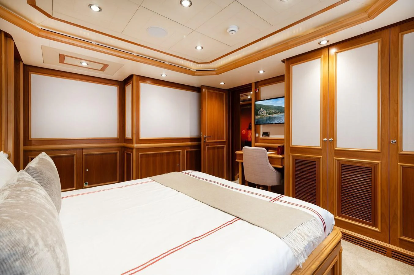 The stateroom features elegant wood paneling and a comfortable bed, creating a warm and inviting atmosphere. aboard EMOTION 2 Yacht for Sale