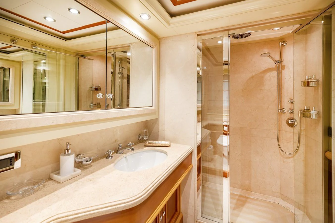 The yacht's bathroom features a spacious shower and elegant vanity with ample lighting. aboard EMOTION 2 Yacht for Sale