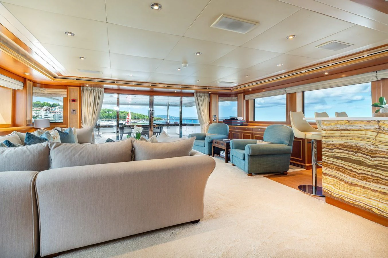 The spacious salon features comfortable seating and large windows offering stunning views. aboard EMOTION 2 Yacht for Sale