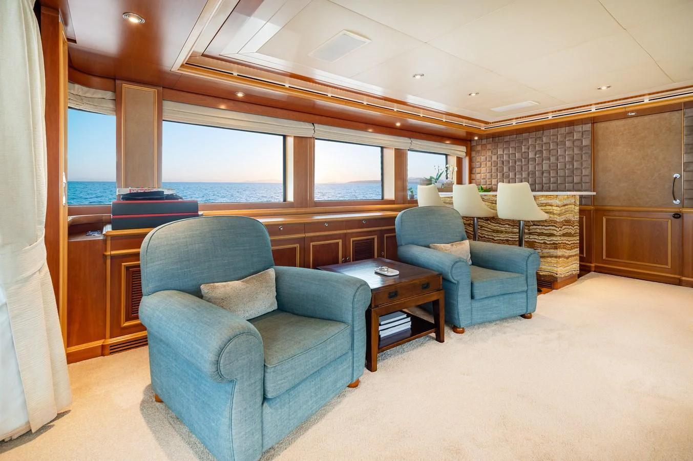The salon offers a spacious and comfortable seating area with large windows providing stunning ocean views. aboard EMOTION 2 Yacht for Sale