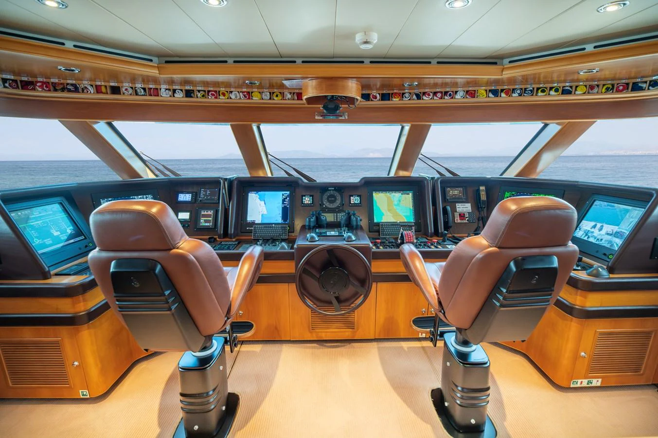 The helm station features state-of-the-art navigation equipment and luxurious seating with panoramic ocean views. aboard EMOTION 2 Yacht for Sale