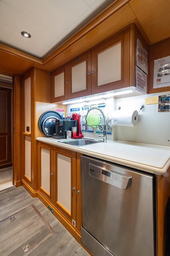 The yacht's galley features modern appliances and ample storage space, creating a functional and stylish cooking area. aboard EMOTION 2 Yacht for Sale