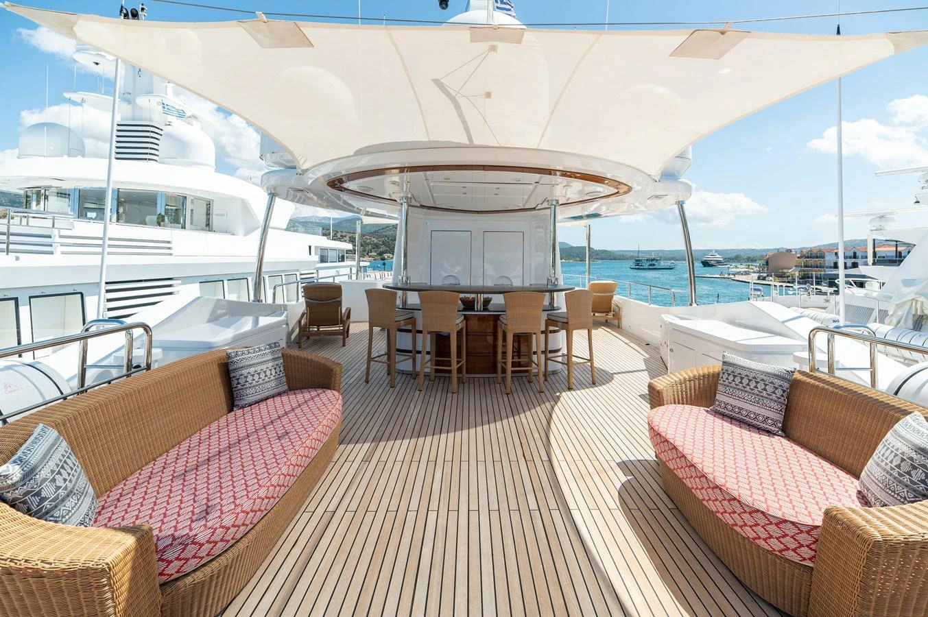 The sundeck offers a spacious and inviting area with comfortable seating and a shaded dining space. aboard EMOTION 2 Yacht for Sale