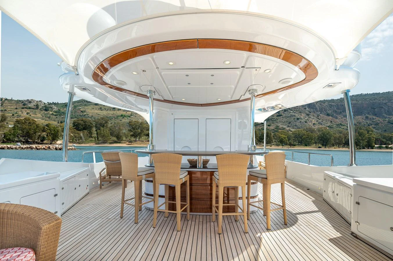 The aft deck features a stylish bar area with comfortable seating, perfect for socializing and enjoying the view. aboard EMOTION 2 Yacht for Sale