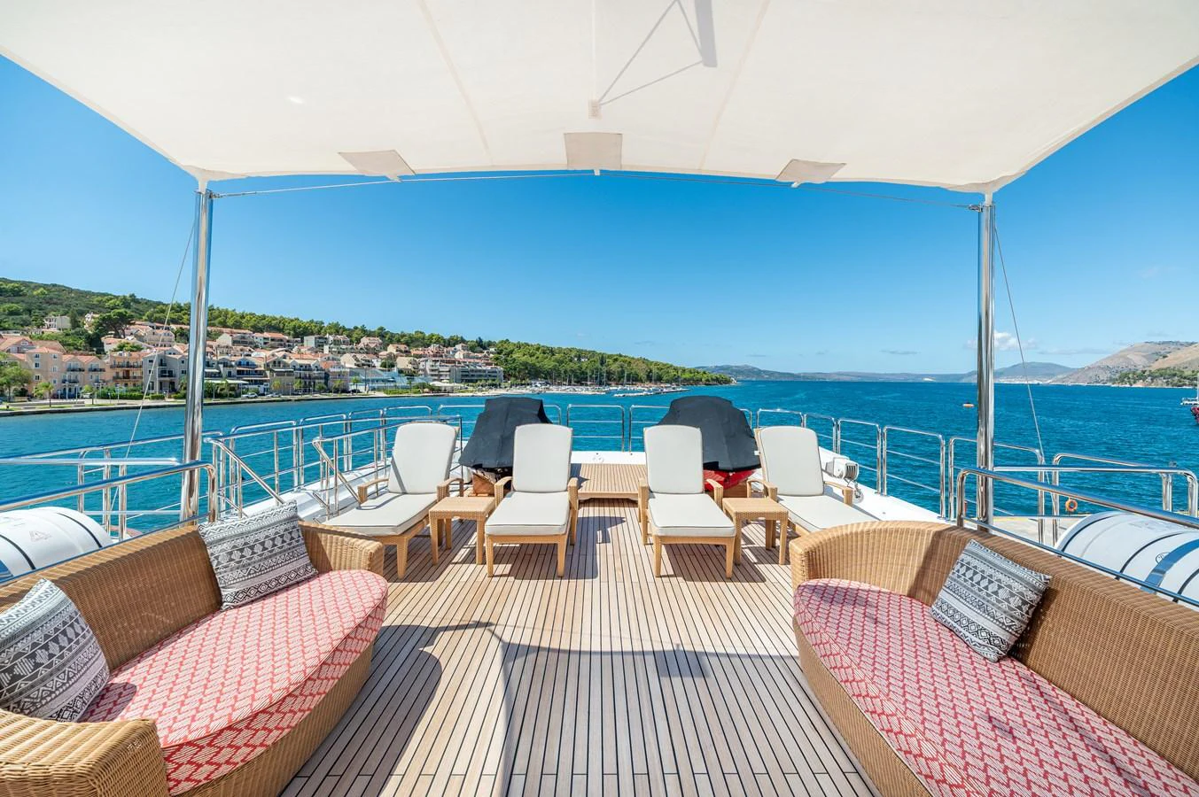 The sundeck offers a spacious and inviting area with comfortable seating and sun loungers, perfect for relaxation while enjoying the scenic views. aboard EMOTION 2 Yacht for Sale