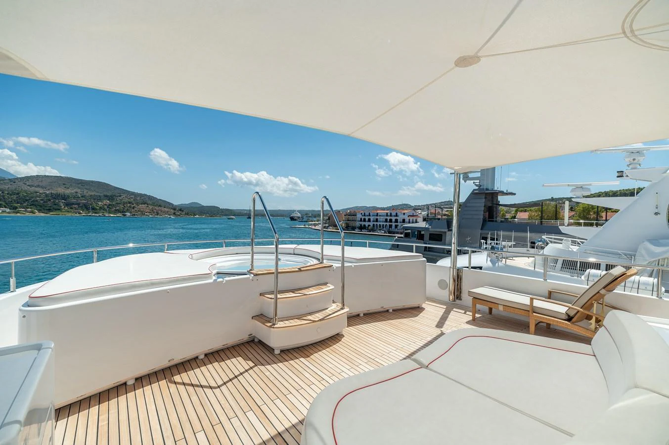 The sundeck offers a luxurious space with a jacuzzi and sun loungers, perfect for relaxation. aboard EMOTION 2 Yacht for Sale