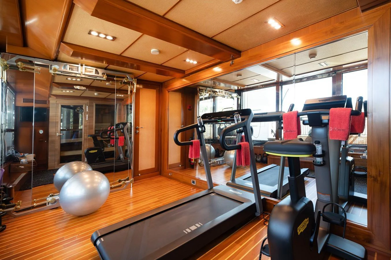 The yacht features a well-equipped gym with modern fitness equipment and ample natural light. aboard EMOTION 2 Yacht for Sale
