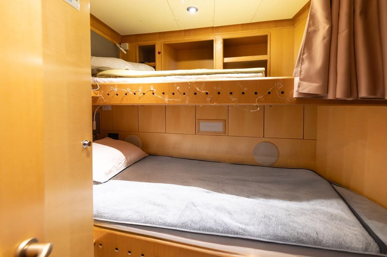 A cozy cabin with bunk beds and warm wooden finishes. aboard EMOTION 2 Yacht for Sale