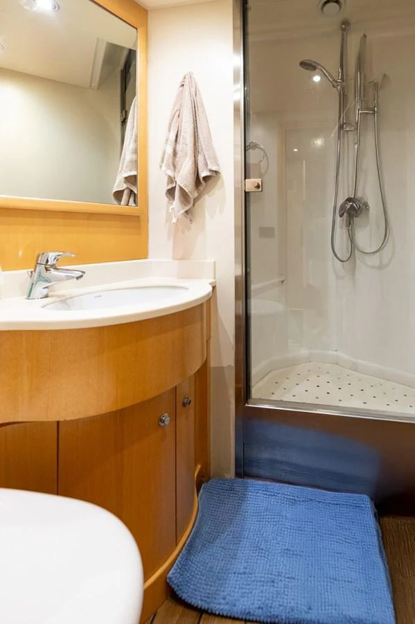 The yacht's bathroom features a sleek shower and a modern vanity with a mirror. aboard EMOTION 2 Yacht for Sale