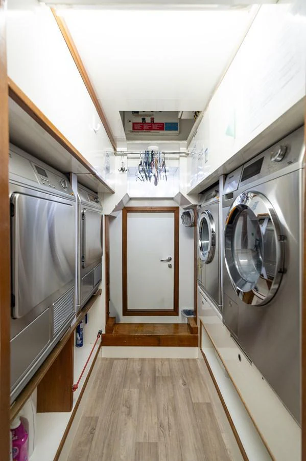 The yacht features a well-equipped laundry room with modern appliances. aboard EMOTION 2 Yacht for Sale