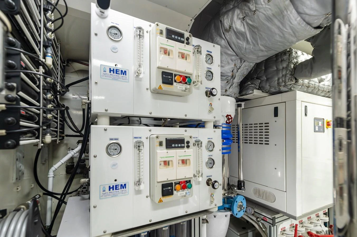 The image showcases the technical equipment and machinery within the yacht's engine room. aboard EMOTION 2 Yacht for Sale