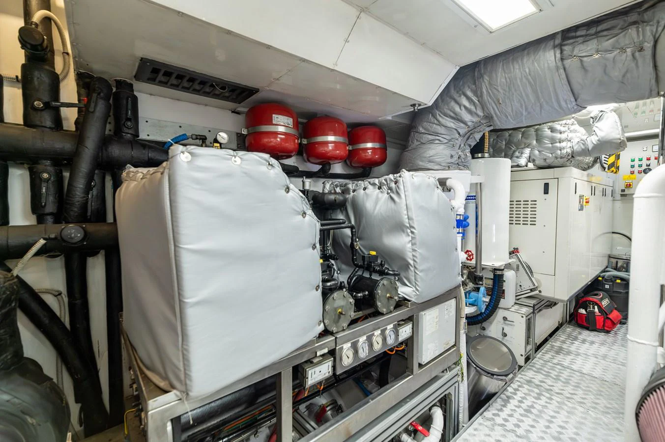 The image showcases the well-maintained engine room of the yacht, featuring various machinery and equipment. aboard EMOTION 2 Yacht for Sale