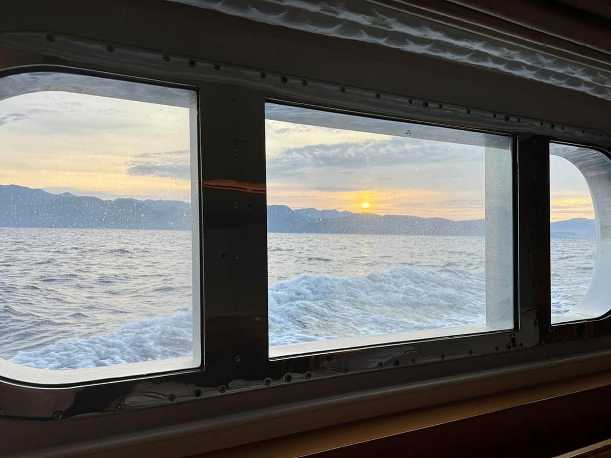A serene view of the ocean and sunset through the yacht's window. aboard EMOTION 2 Yacht for Sale