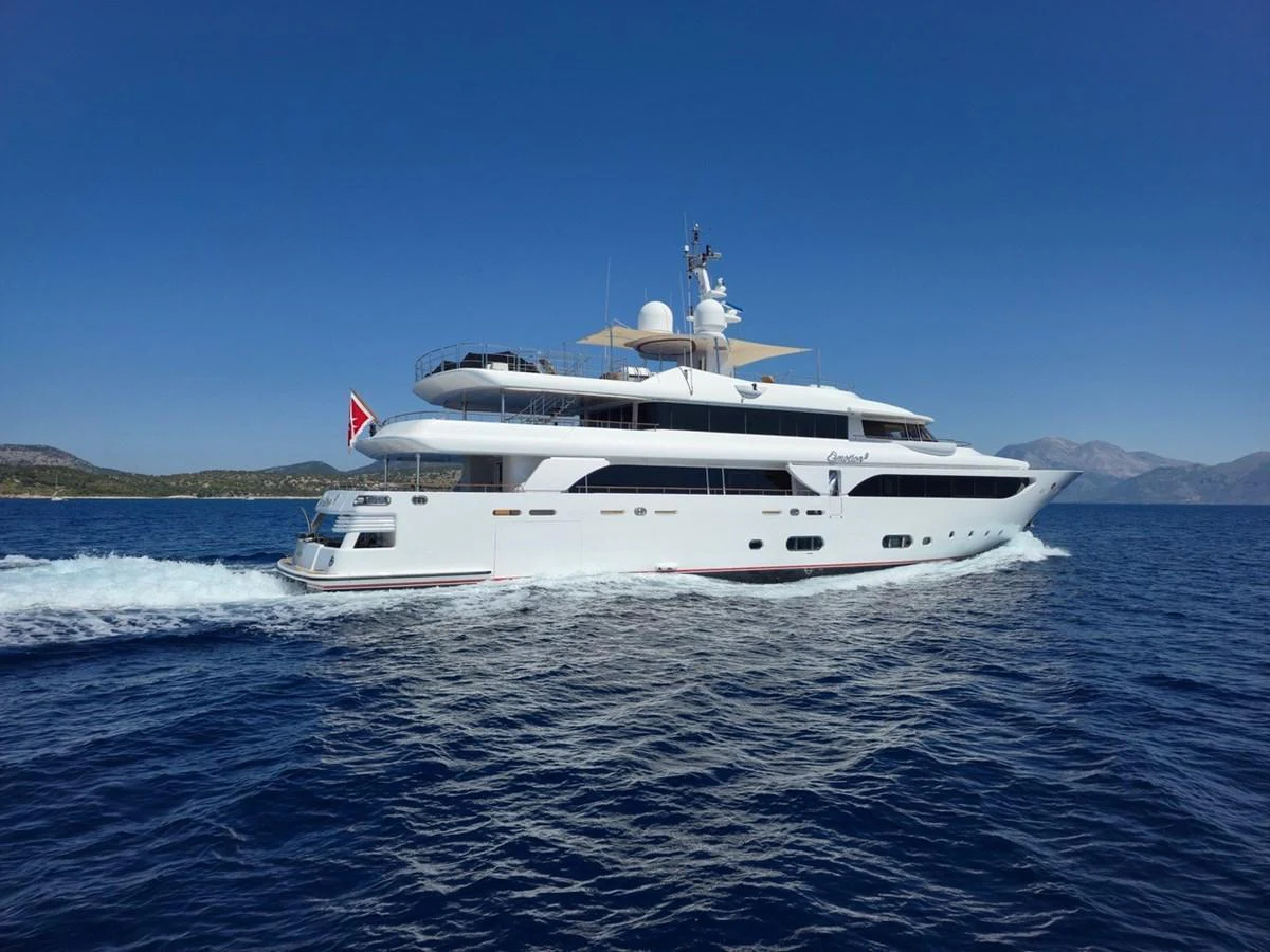 A sleek and elegant yacht cruising on calm blue waters under a clear sky. aboard EMOTION 2 Yacht for Sale