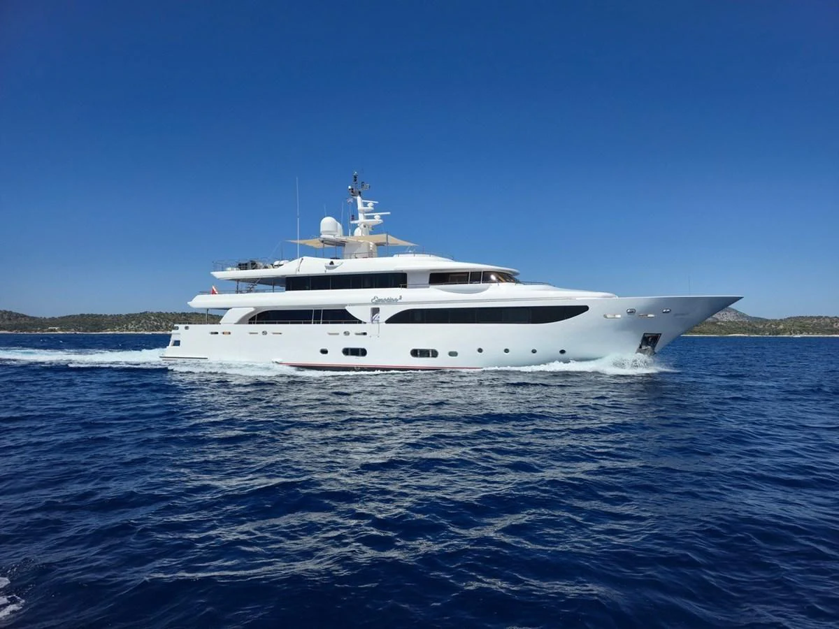 A sleek and modern yacht cruises smoothly on the open water under a clear blue sky. aboard EMOTION 2 Yacht for Sale