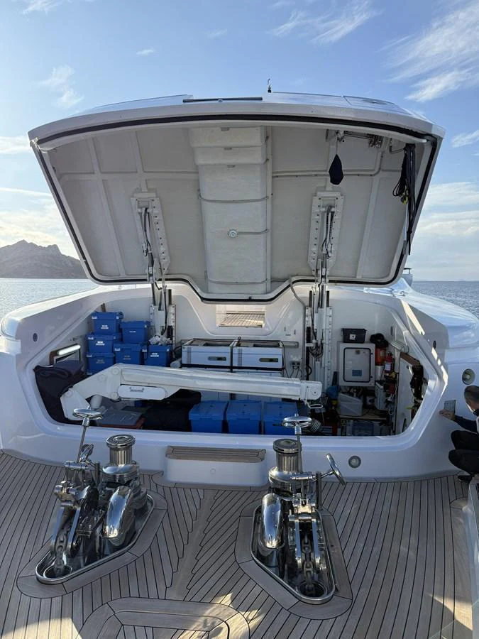 The image showcases the yacht's technical compartment with open access to various equipment and storage. aboard EMOTION 2 Yacht for Sale