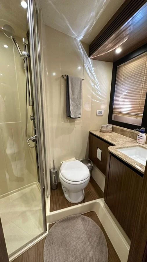 A compact and well-appointed yacht bathroom with modern fixtures. aboard NINE NINE WINE Yacht for Sale