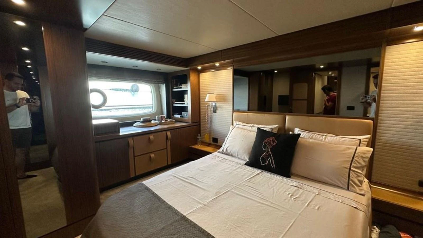 A luxurious stateroom featuring a comfortable bed and elegant wood finishes. aboard NINE NINE WINE Yacht for Sale