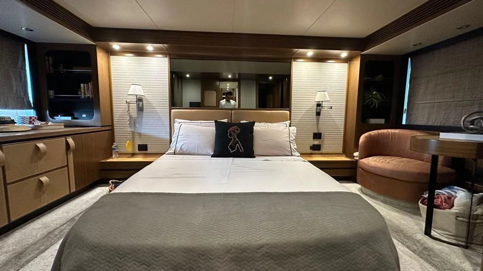 The master stateroom features a luxurious bed with elegant lighting and ample storage space. aboard NINE NINE WINE Yacht for Sale