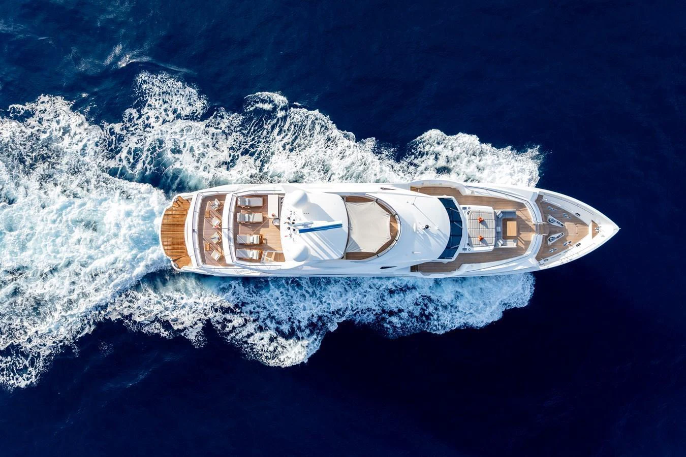 A stunning aerial view of a luxurious yacht cruising through the deep blue sea. aboard ALADDIN Yacht for Sale