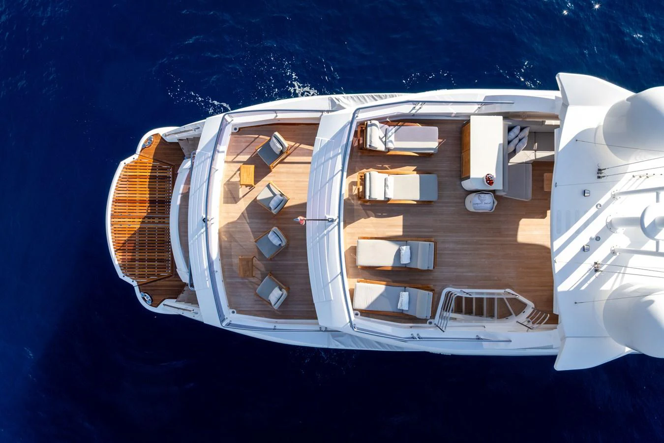 The sundeck offers a luxurious space for relaxation with multiple sun loungers and seating areas. aboard ALADDIN Yacht for Sale