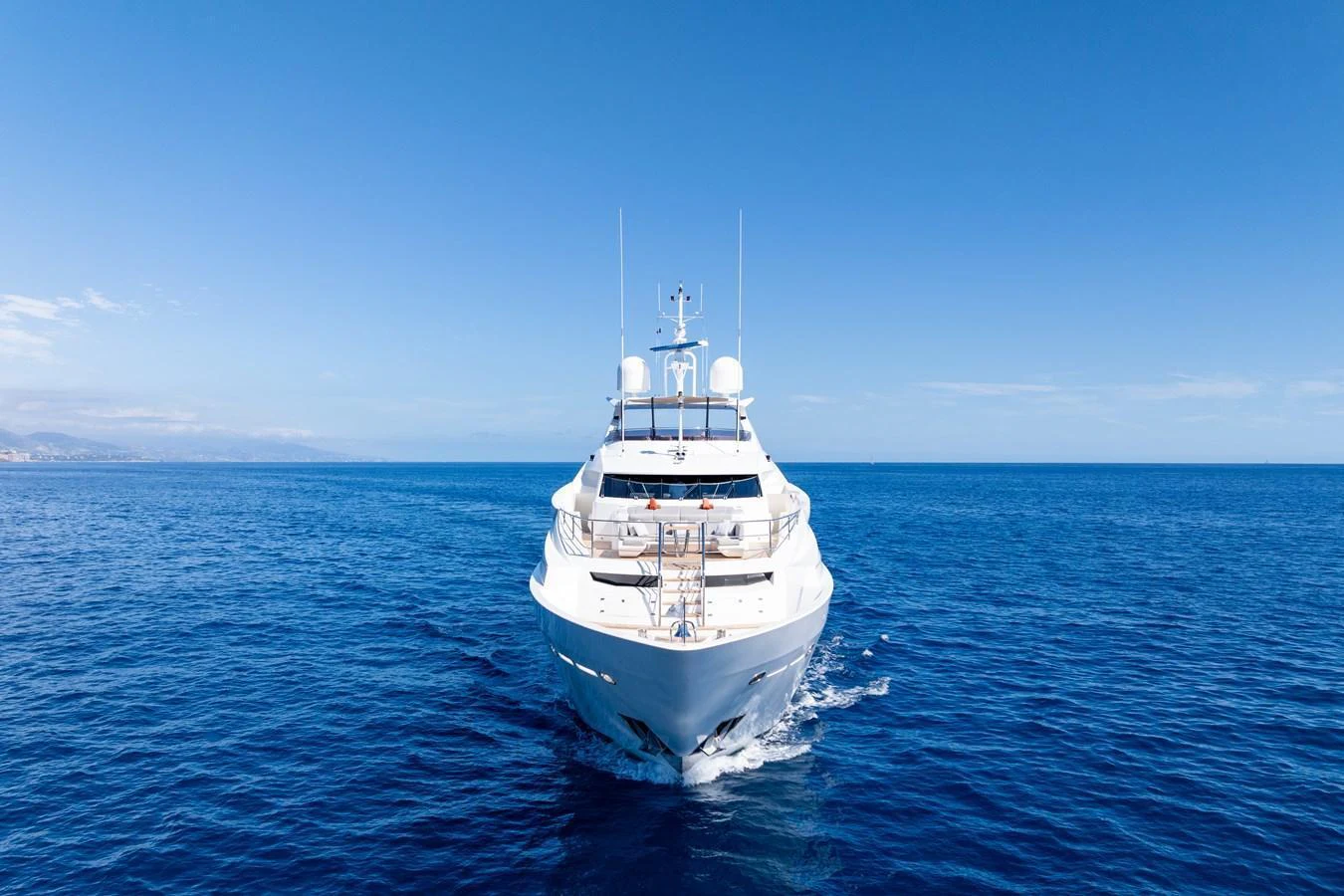 A luxurious yacht cruising on the open sea under a clear blue sky. aboard ALADDIN Yacht for Sale
