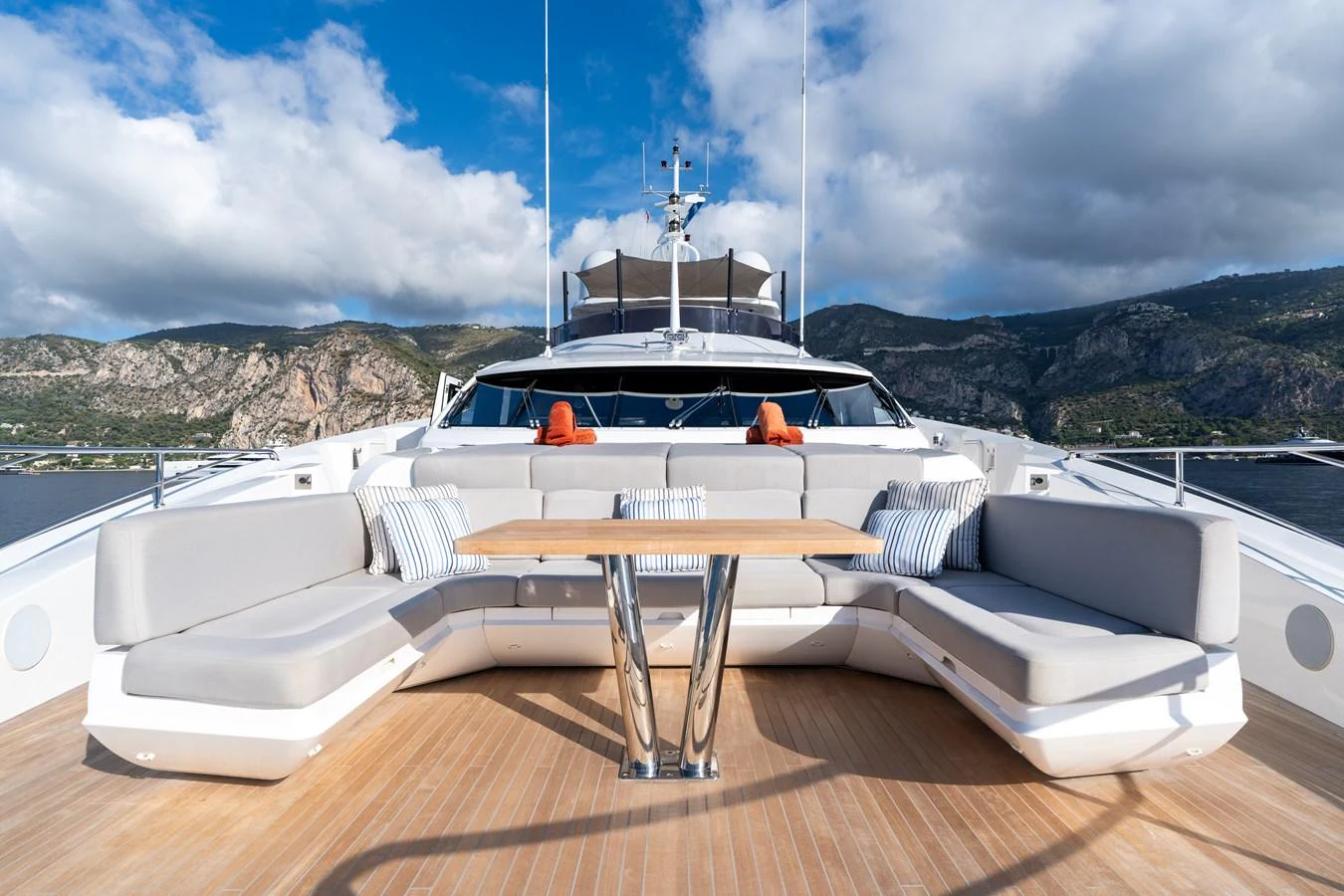 The foredeck features a spacious seating area with a central table, perfect for relaxation and enjoying the view. aboard ALADDIN Yacht for Sale