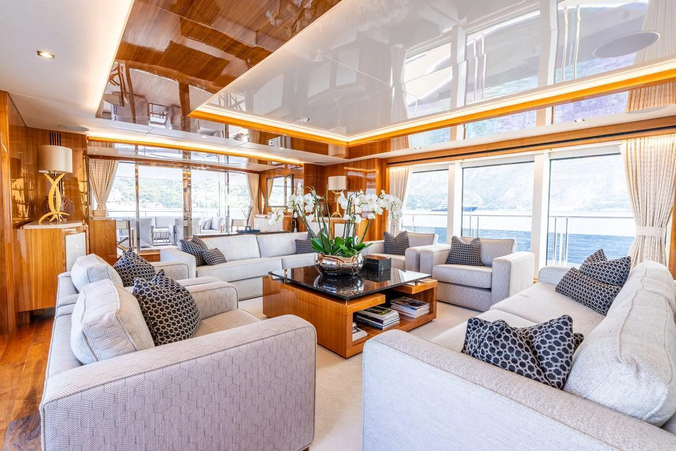 The spacious salon features luxurious seating and elegant decor with panoramic views. aboard ALADDIN Yacht for Sale