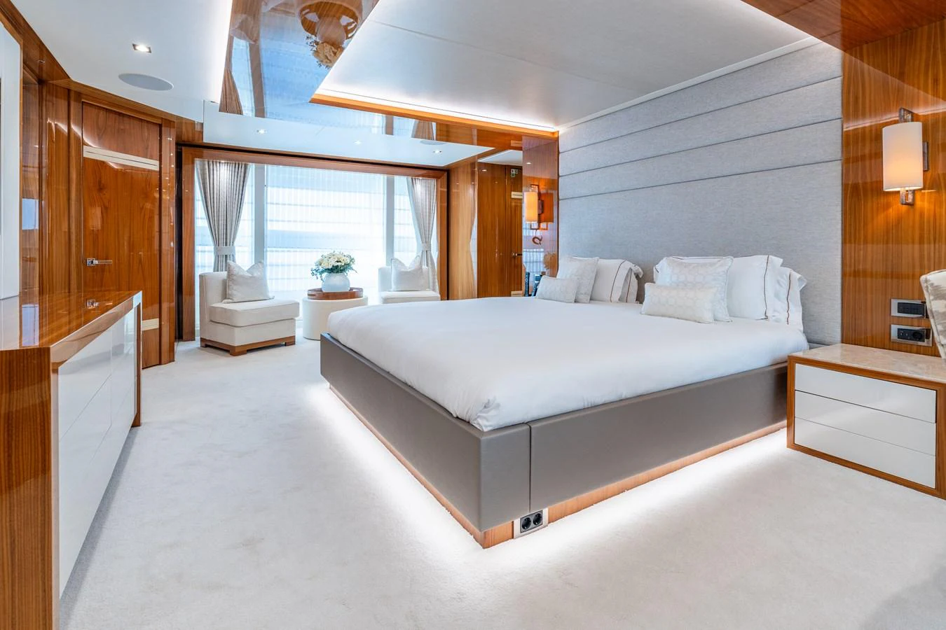 The master stateroom features a spacious bed, elegant wood finishes, and ample natural light. aboard ALADDIN Yacht for Sale