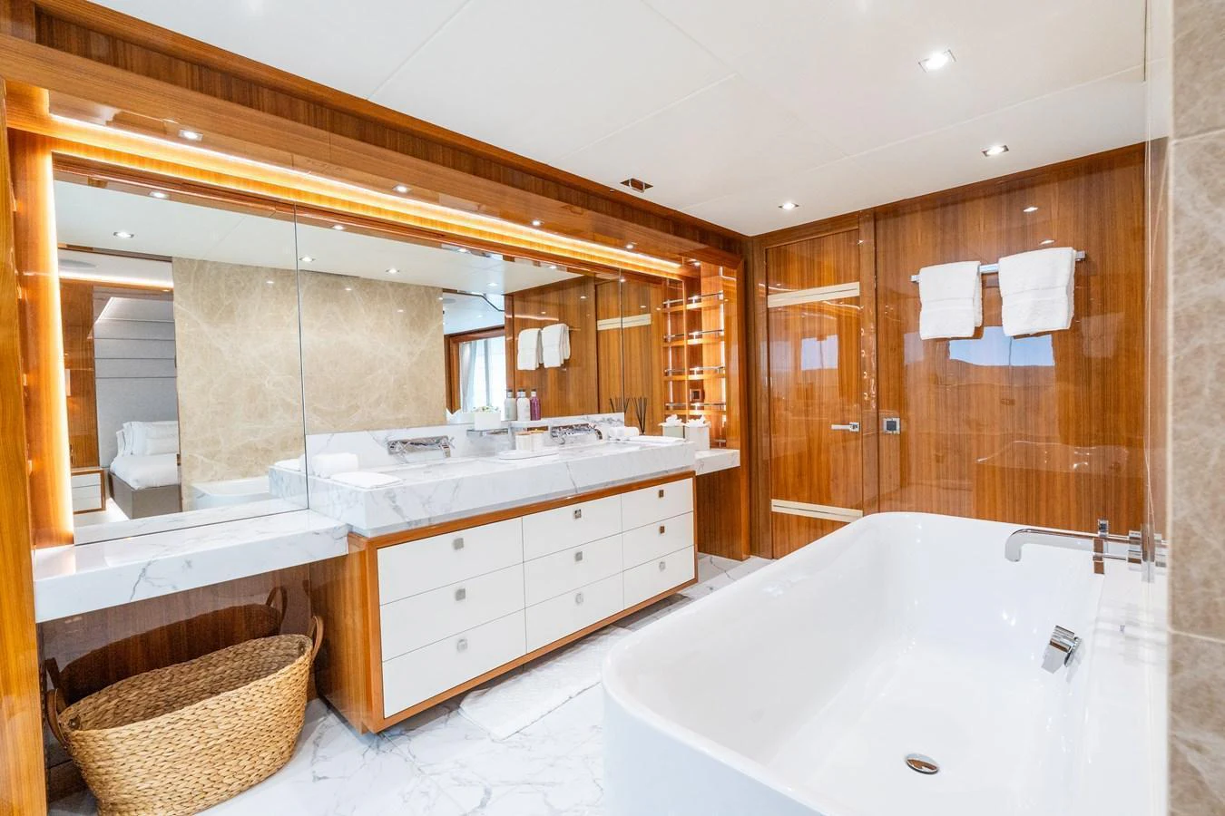 The yacht's bathroom features luxurious marble countertops, a spacious bathtub, and elegant wooden cabinetry. aboard ALADDIN Yacht for Sale
