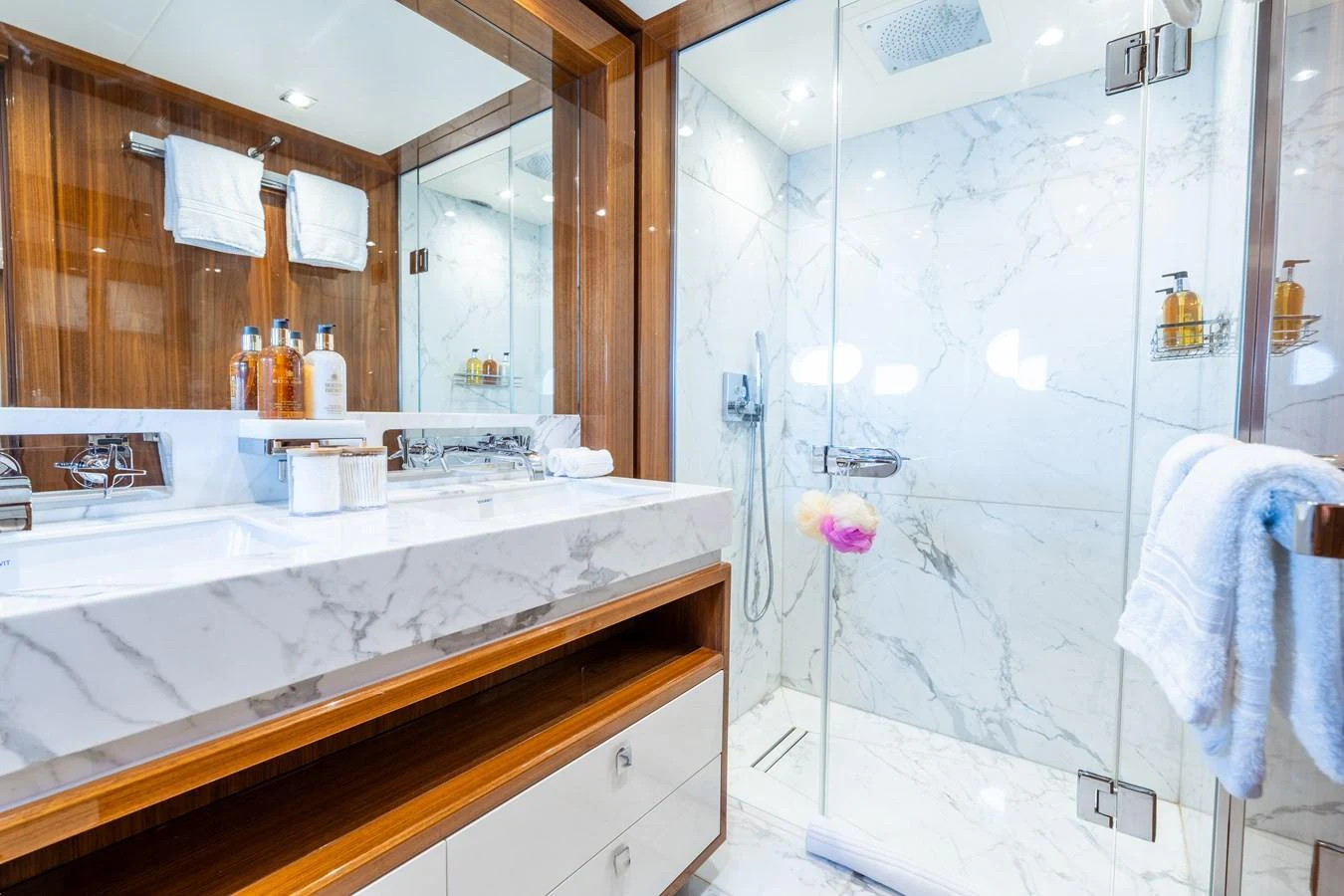 The yacht's bathroom features a luxurious marble sink and a spacious glass-enclosed shower. aboard ALADDIN Yacht for Sale