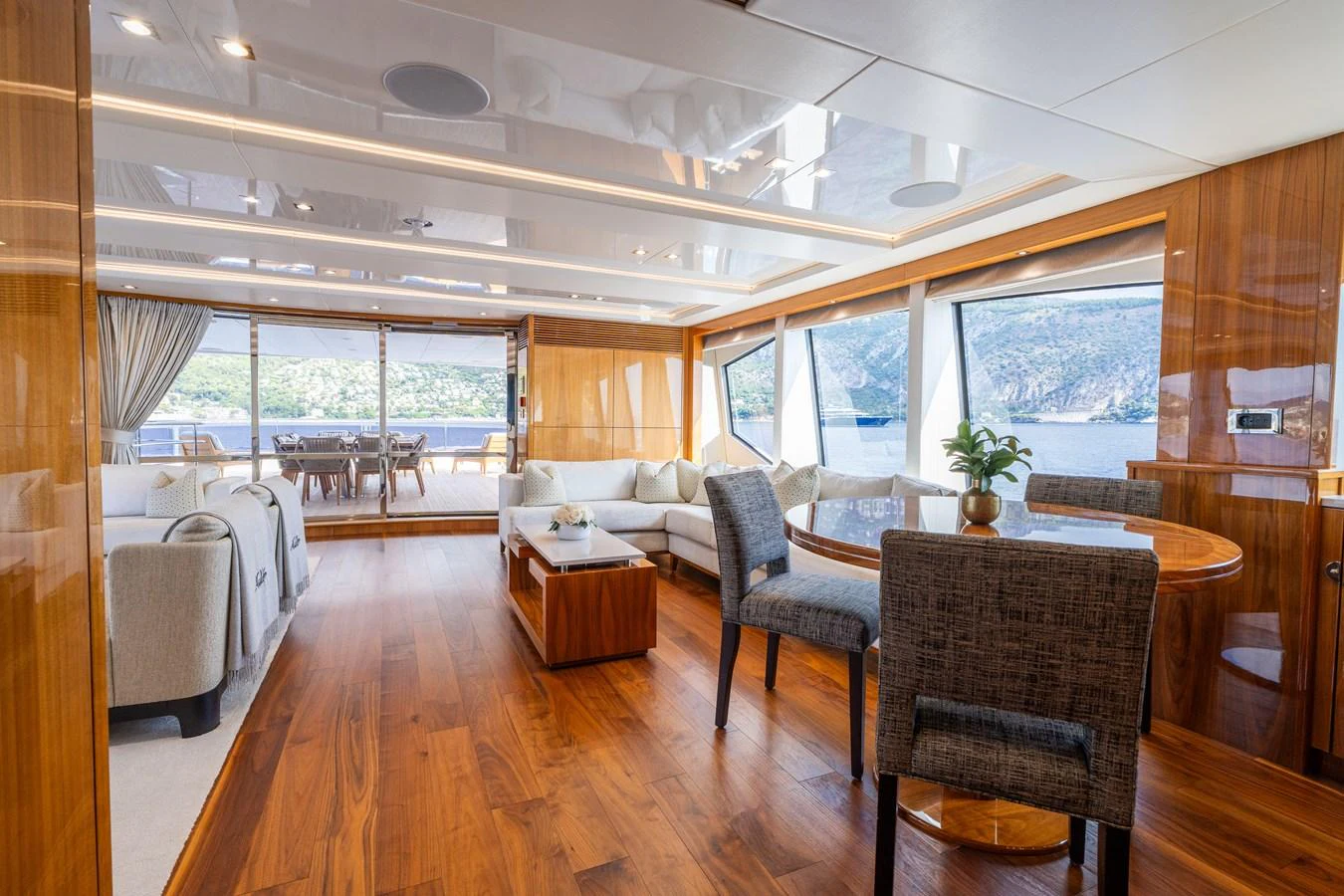 The spacious salon features elegant wood finishes, comfortable seating, and large windows offering stunning views. aboard ALADDIN Yacht for Sale