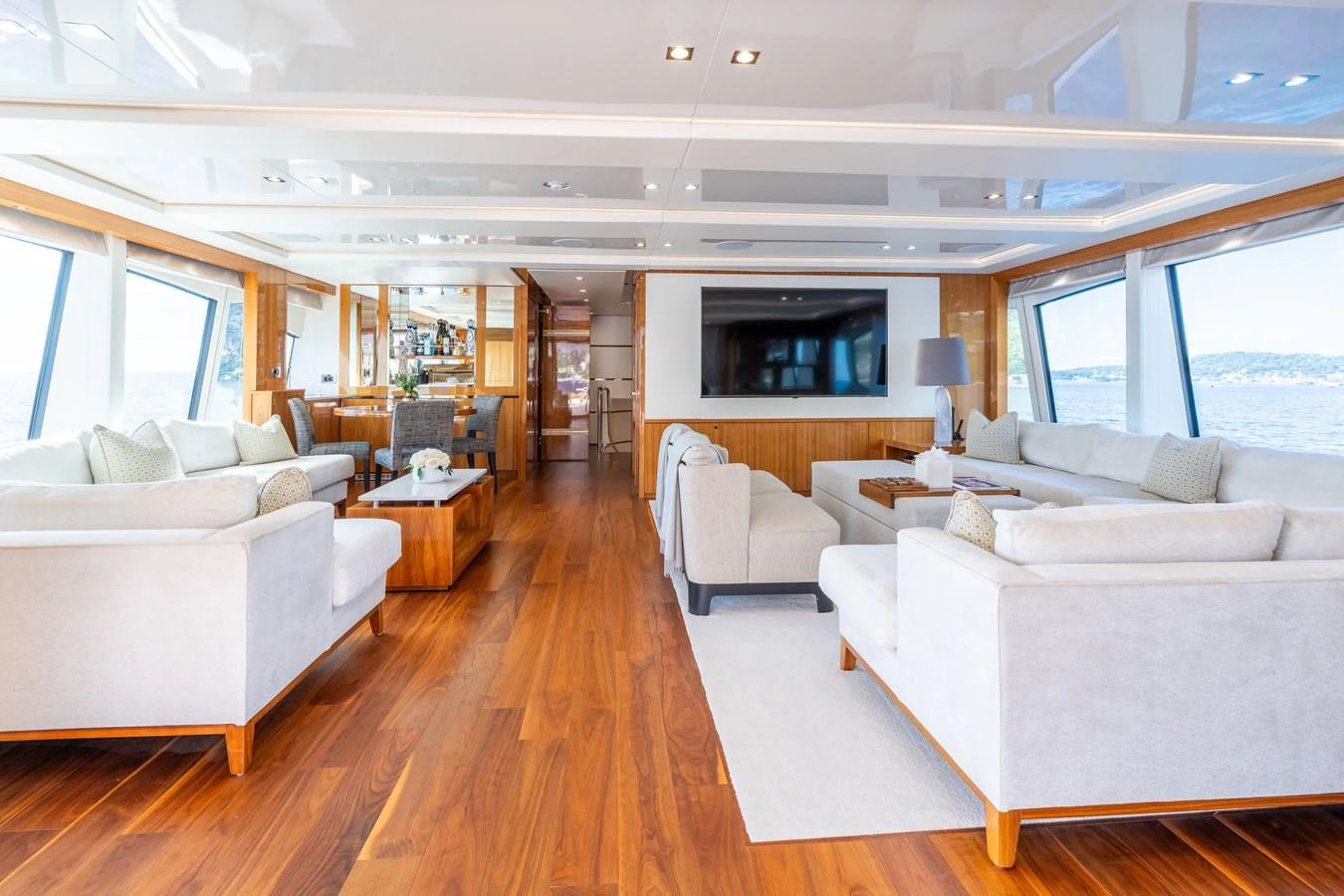 The spacious salon features elegant seating and large windows offering panoramic views. aboard ALADDIN Yacht for Sale