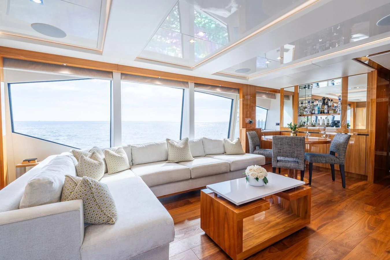 The salon features a spacious seating area with panoramic windows offering stunning ocean views. aboard ALADDIN Yacht for Sale