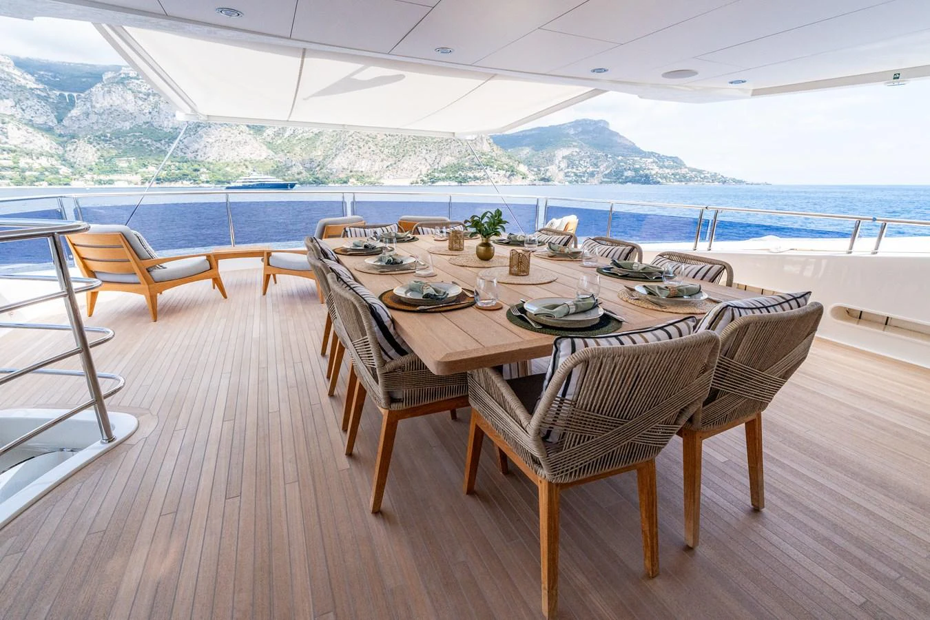 The aft deck features an elegant dining area with a stunning ocean view. aboard ALADDIN Yacht for Sale