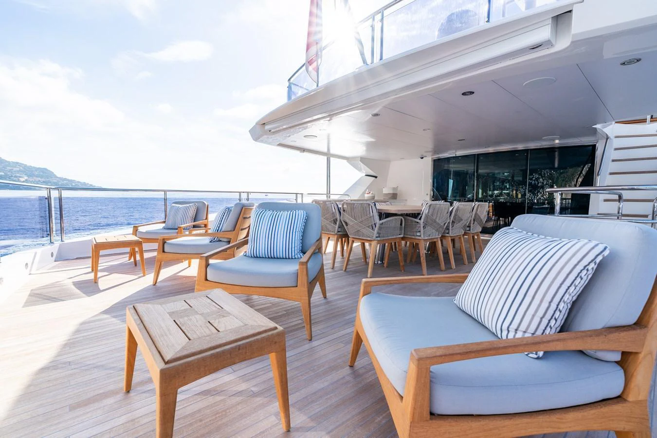 The aft deck features comfortable seating and a dining area with stunning ocean views. aboard ALADDIN Yacht for Sale