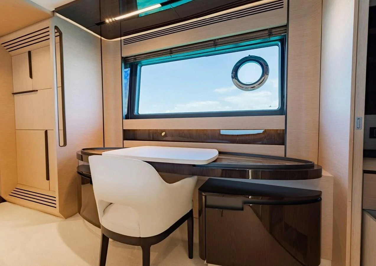The yacht's office features a sleek desk with a comfortable chair and a large window offering a view of the sea. aboard LANCE WEST Yacht for Sale
