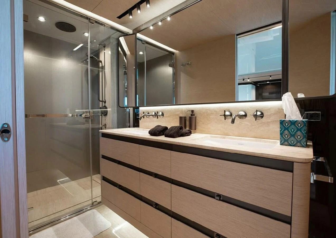 A modern yacht bathroom with a spacious shower and elegant fixtures. aboard LANCE WEST Yacht for Sale