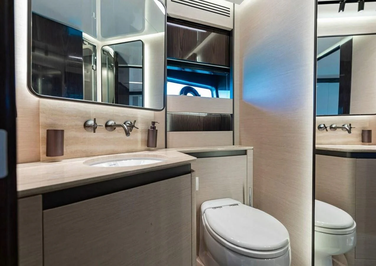 The yacht's bathroom features modern fixtures and a sleek design with ample lighting. aboard LANCE WEST Yacht for Sale