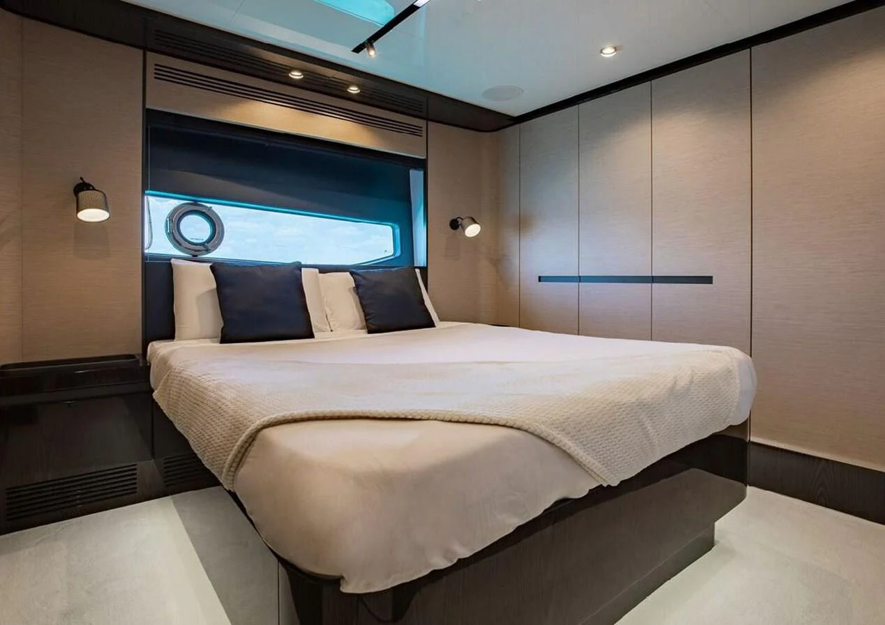 The stateroom features a luxurious bed with elegant lighting and ample storage space. aboard LANCE WEST Yacht for Sale