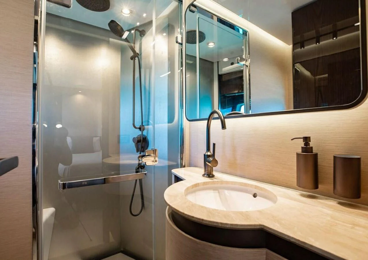 The yacht's bathroom features a modern design with a glass-enclosed shower and sleek fixtures. aboard LANCE WEST Yacht for Sale