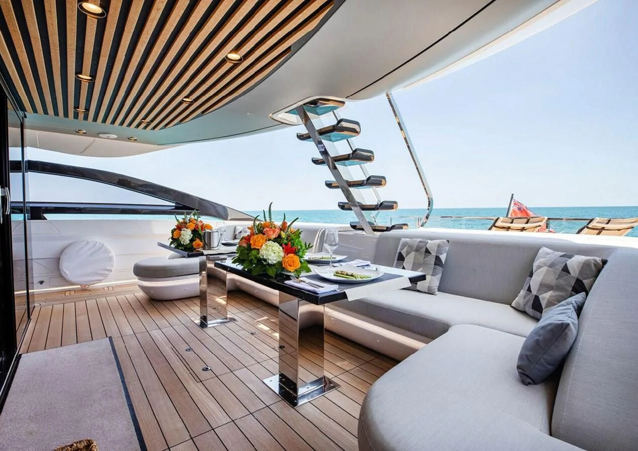 The aft deck features a stylish dining area with a view of the ocean, perfect for alfresco meals. aboard LANCE WEST Yacht for Sale