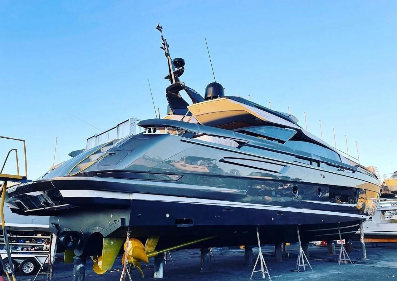 A sleek and modern yacht is showcased on dry dock, highlighting its streamlined design and luxurious features. aboard LANCE WEST Yacht for Sale