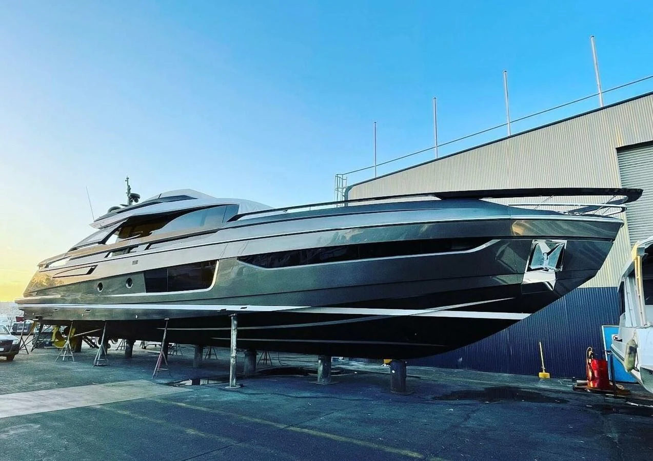 A sleek and modern yacht is showcased on dry dock, highlighting its streamlined design and luxurious build. aboard LANCE WEST Yacht for Sale