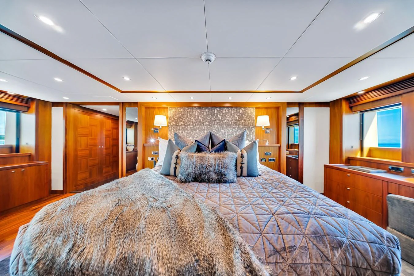 The master stateroom exudes luxury with its plush bedding and warm wood finishes. aboard NATURAL 9 Yacht for Sale