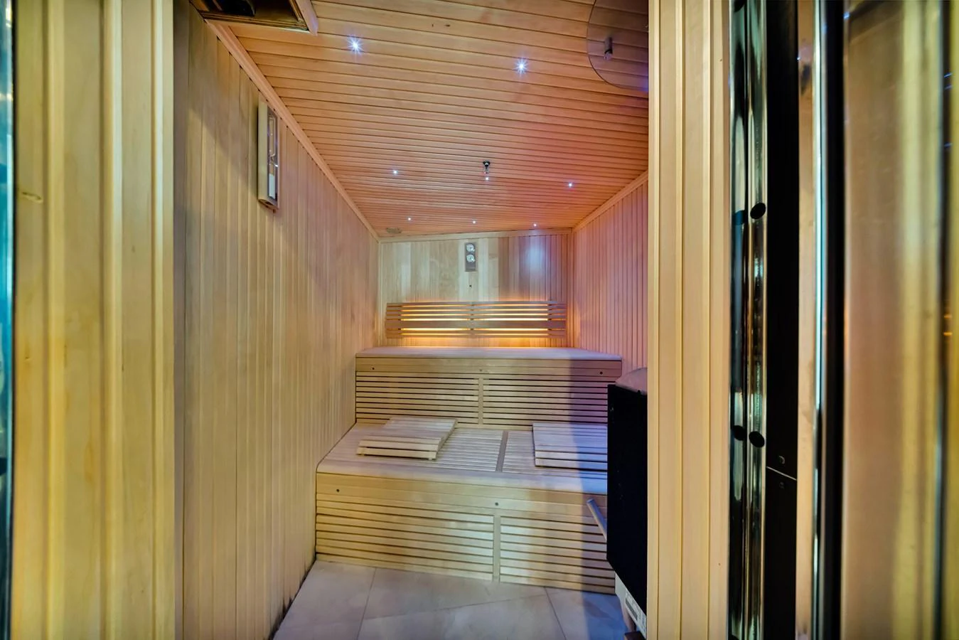 The yacht features a luxurious sauna with wooden interiors and ambient lighting. aboard NATURAL 9 Yacht for Sale